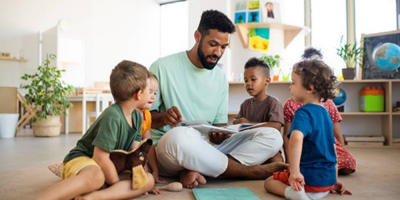 man reading with children