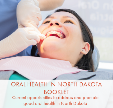 Women in dental chair having her mouth examined by a dentist.