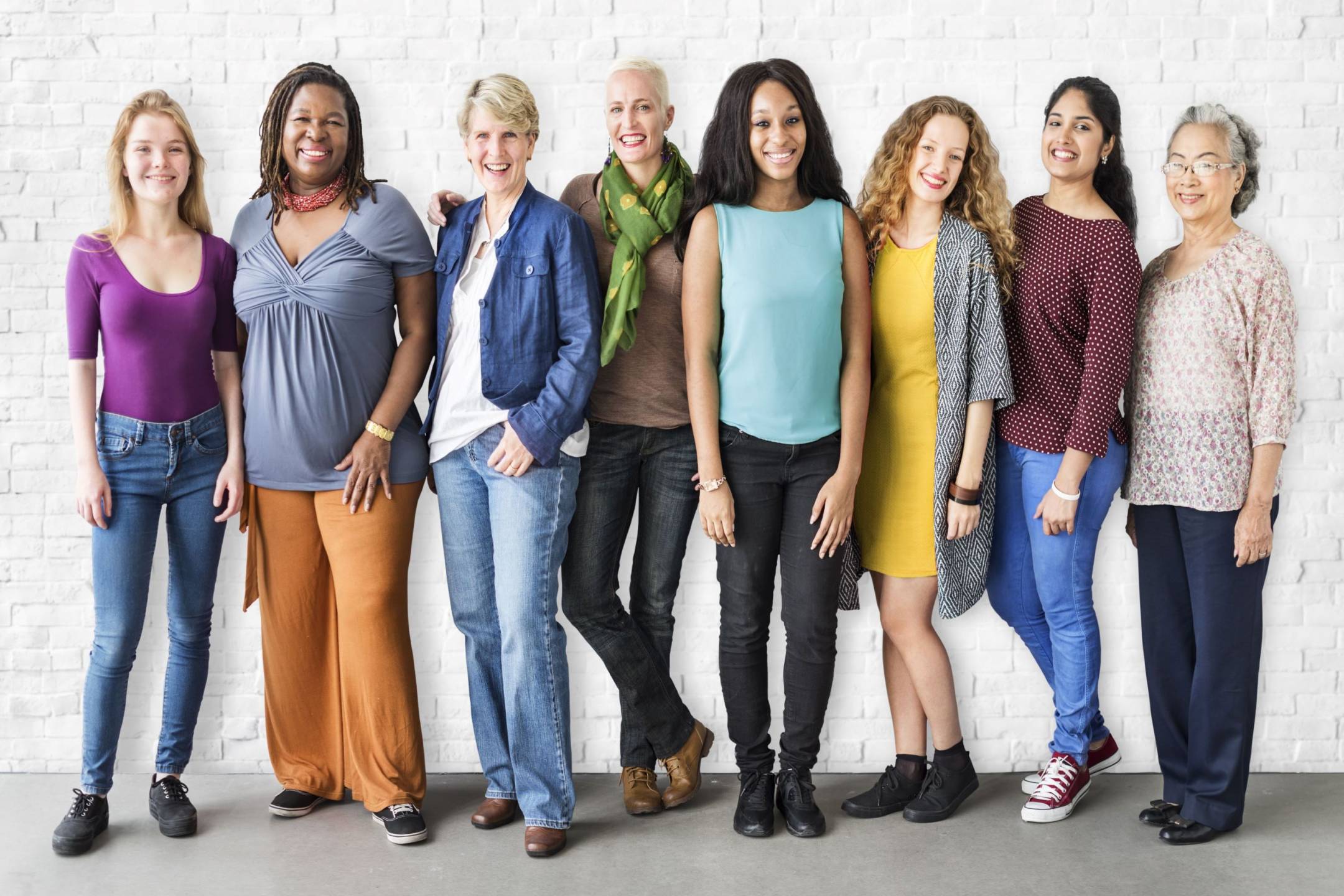 Eight smiling women, varying race and age