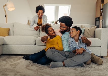 family smiling in their home
