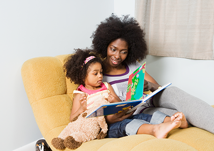 a mother and daughter reading a book together