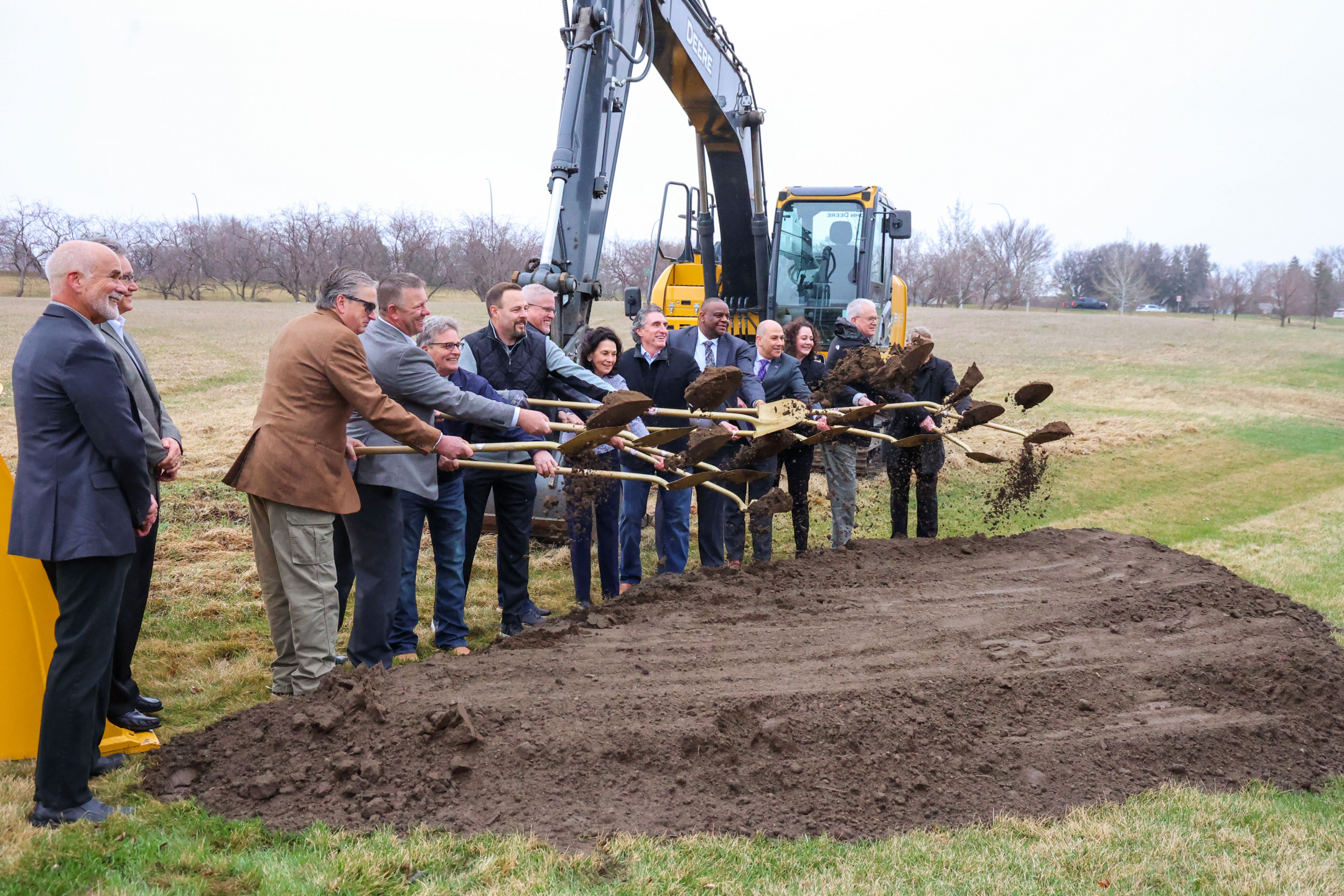 A group of government dig the first shovel-fulls of dirt from the state lab construction site.