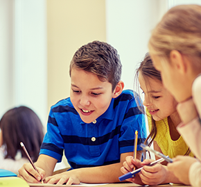 Three young students happily work together.