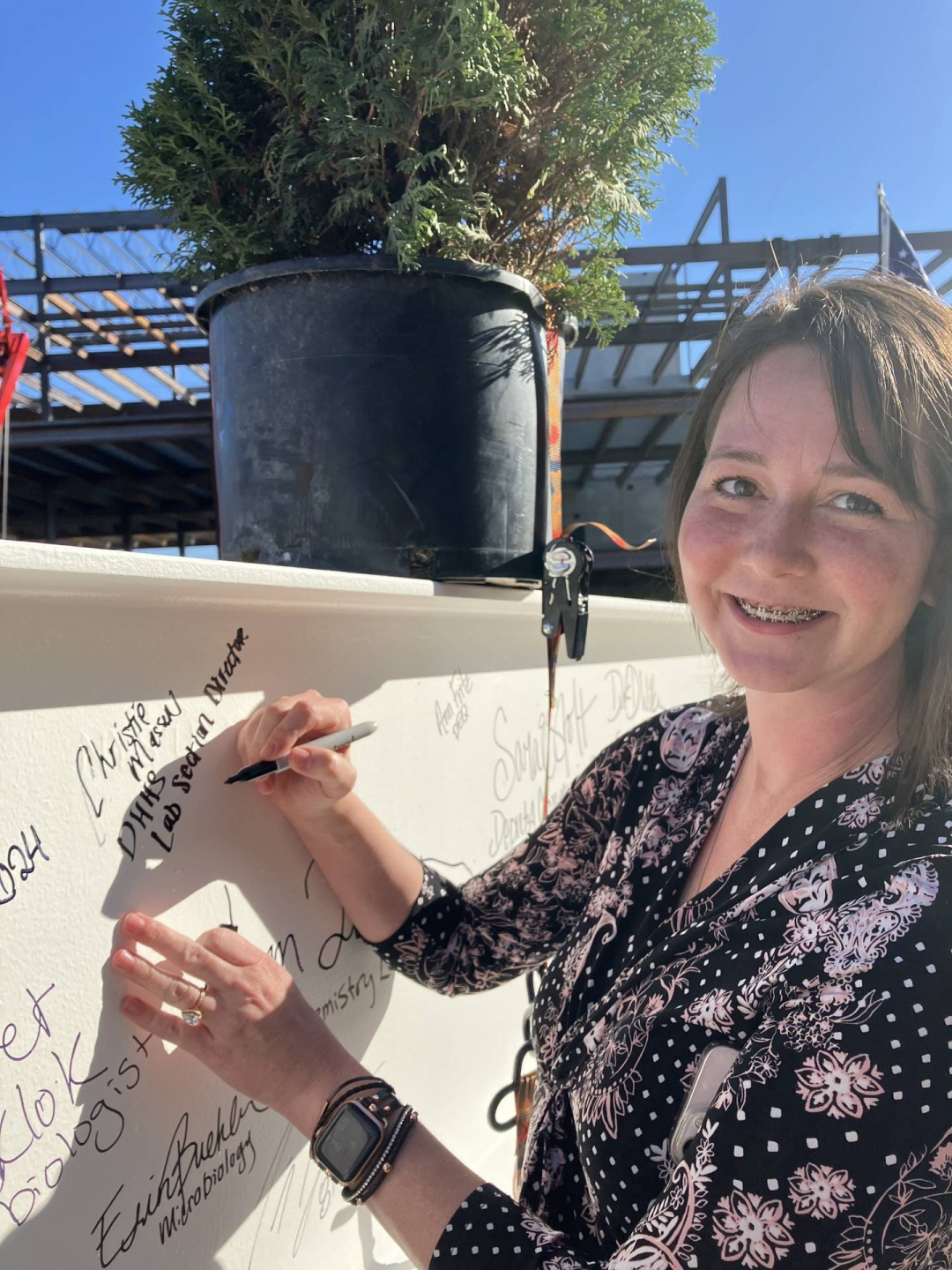 HHS Lab Section Director Christie Massen signs the beam