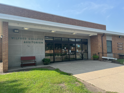 Entrance Collette Fitness Center - light colored brick with sliding doors