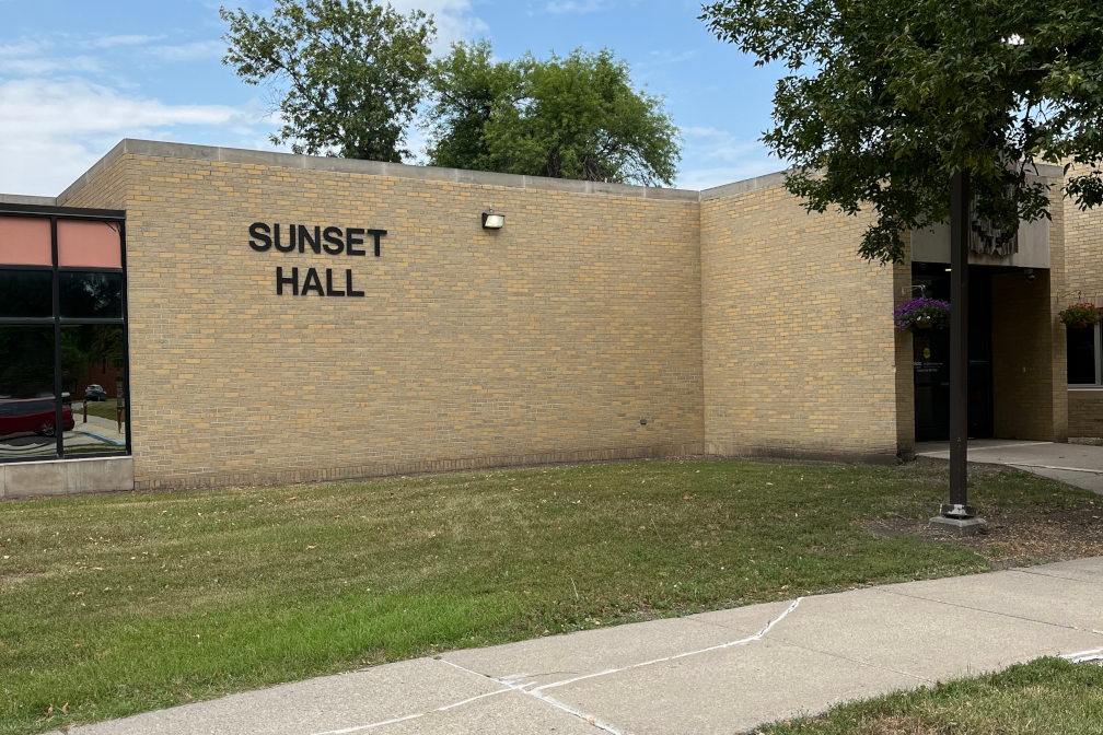 Sunset Hall Building light brick with black writing