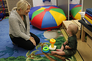 Picture of child with therapist playing with rings