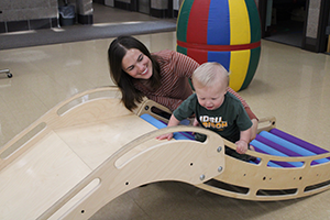 picture of a child crawling on therapy slide