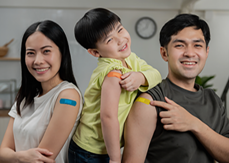A family shows the bandages on their arms.
