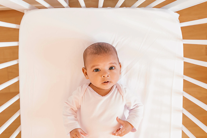 Baby in crib looking at the camera