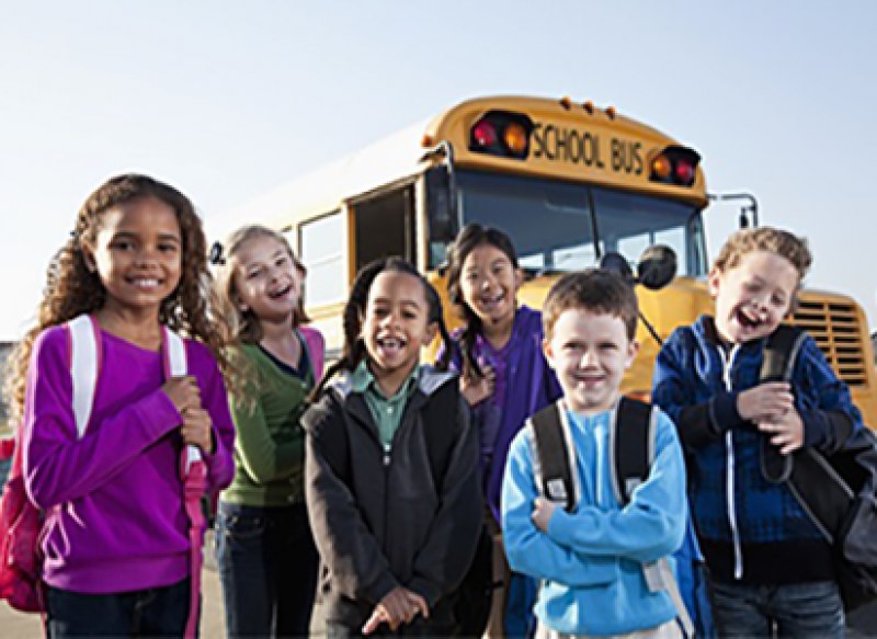 Kids in front of a school bus