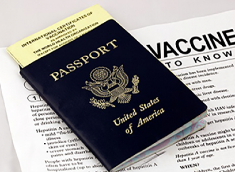 U.S. passport atop vaccine paperwork